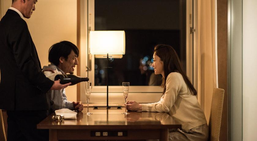 a man and a woman standing in front of a table, Sapporo Park Hotel in Sapporo