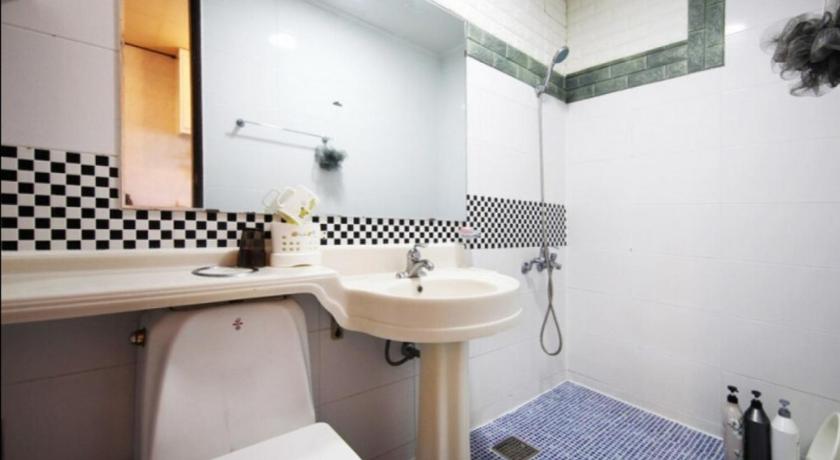 a bathroom with a sink and a toilet, Pureun Jeju Pension in Jeju
