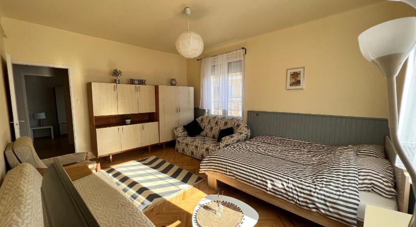 a bedroom with a bed and a desk, Bartok Apartment in Szeged