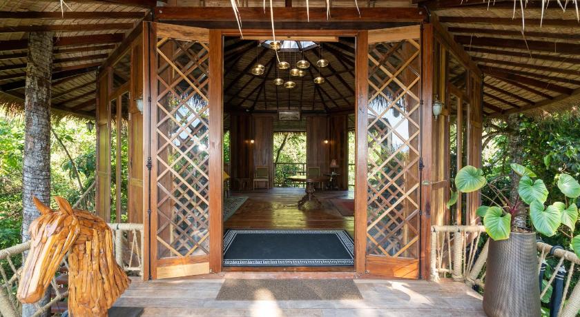 a large room with a wooden door and a canopy, AKRA COLLECTION LAYAN in Phuket