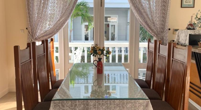 a dining room table with two chairs and a table cloth, Villa Mui Ne Phan Thiet SeaView in Phan Thiet
