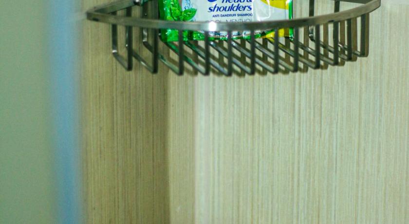 a bottle of toothbrushes sitting on top of a trash can, BIRCH TOWER - MALATE ROOMS in Manila