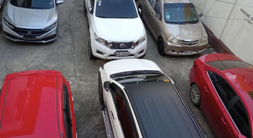 cars parked next to each other in a parking lot, AMARANTA SUITES in Davao City