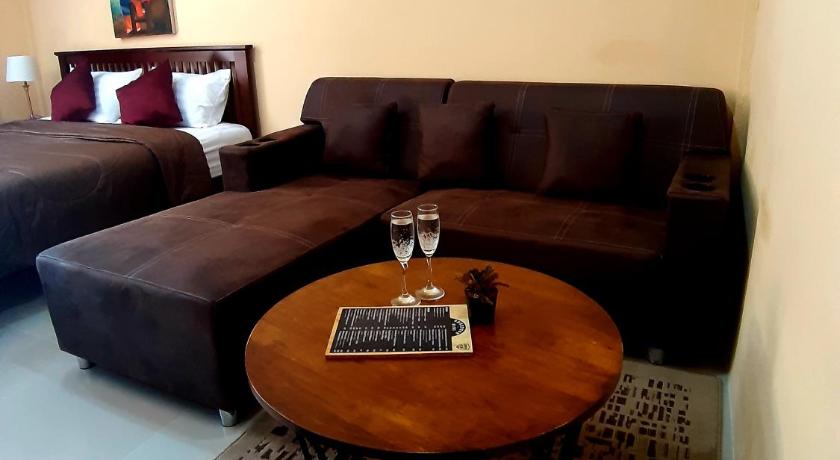 a living room filled with furniture and a coffee table, The Windsor Boutique Resort in Chumphon