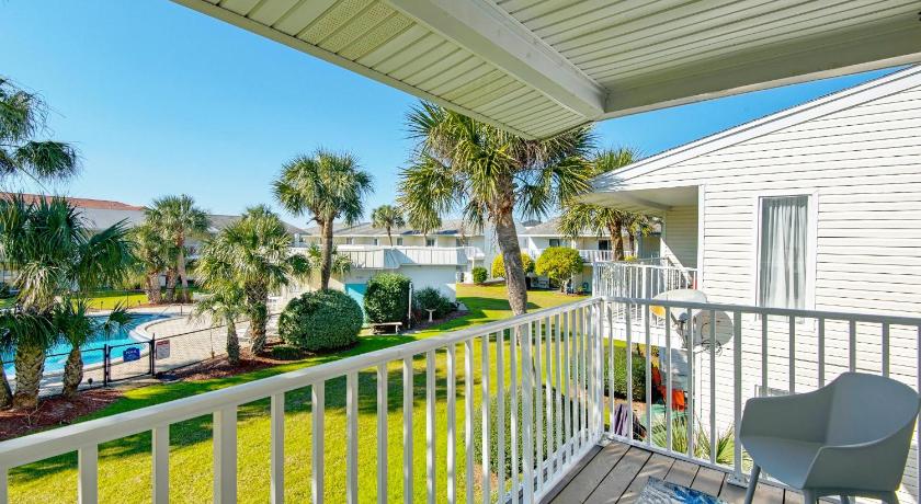 a patio area with chairs, a table, and a balcony, Summerhouse #5 in Destin (FL)