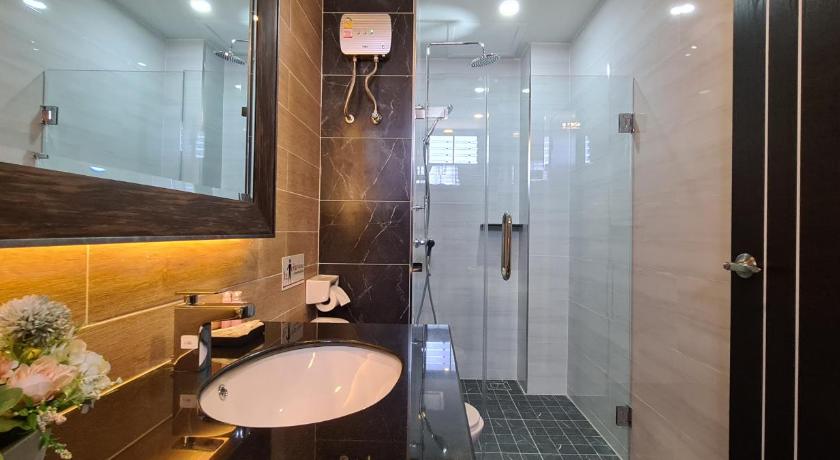 a bathroom with a large mirror and a bath tub, The Room Boutique Hotel in Sakon Nakhon