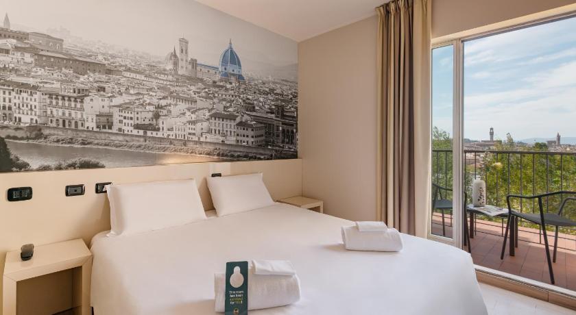 a hotel room with a bed and a painting on the wall, B&B Hotel Firenze City Center in Florence