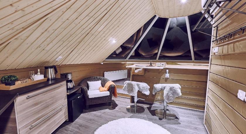 a dog sitting on top of a chair in a room, Pyhan Asteli Aurora Igloos & Suites in Pyhatunturi
