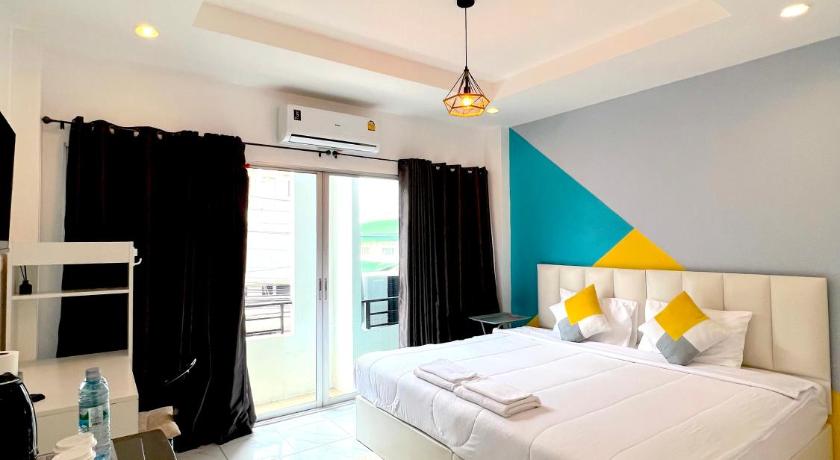 a hotel room with a large bed and a large window, Nap at 265 Donmuang in Bangkok
