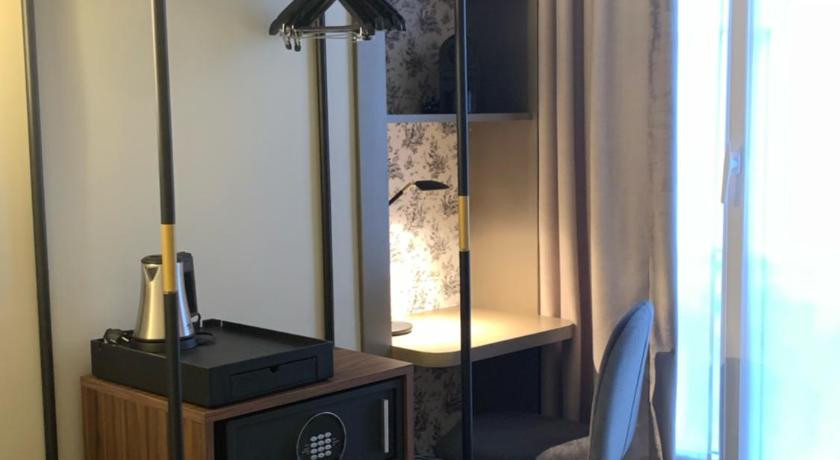 a room with a desk and a lamp on top of it, Hotel Astrid in Paris