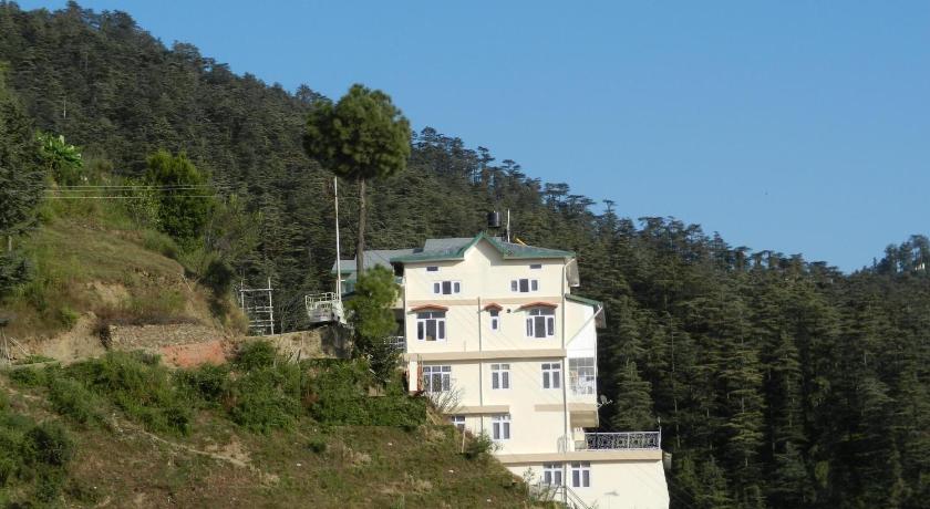 a large white building with a blue roof, Vatsalyam Home Stay in Shimla
