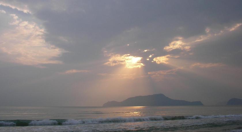 the sun is setting over the ocean on a cloudy day, Privacy Beach Resort & Spa in Prachuap Khiri Khan