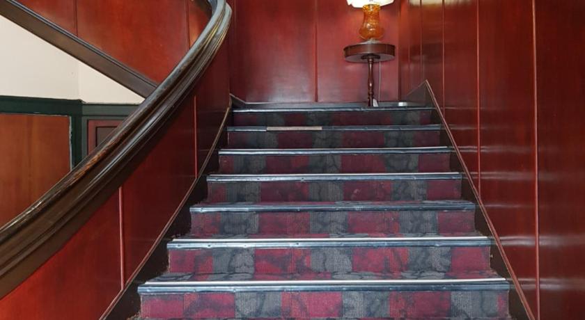 a row of stairs leading up to a stairwell, Northern Wairoa Hotel in Dargaville