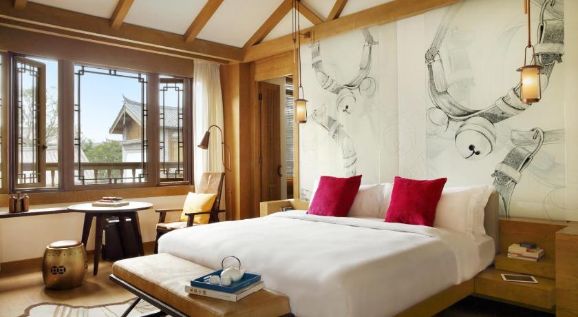 a hotel room with a bed and a painting on the wall, Hotel Indigo Lijiang Ancient Town in Lijiang