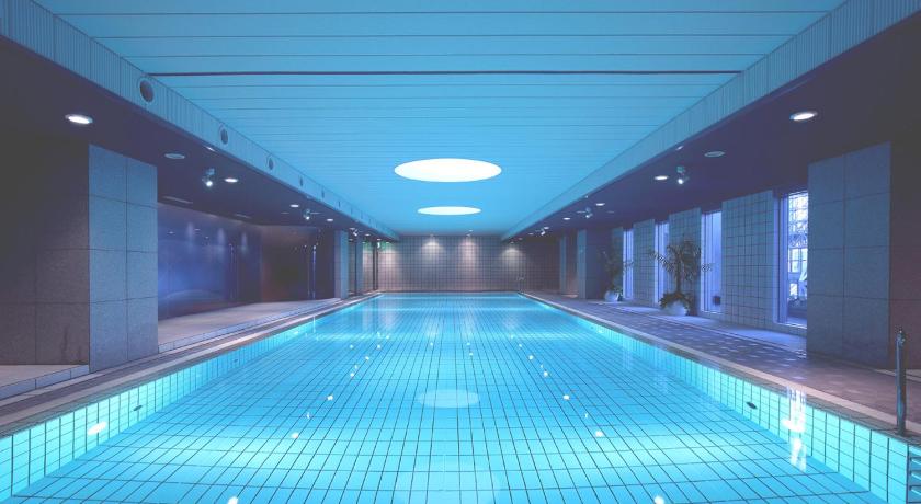 a large swimming pool in a large room, Hotel Granvia Kyoto in Kyoto