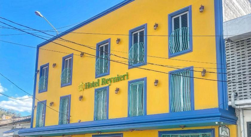 a blue and yellow building with a blue sky, Hotel Reynieri in Tegucigalpa