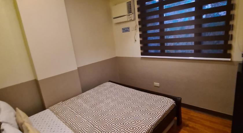 a bedroom with a bed and a window, 722 Metropolis Tower Unit 212 in Bacolod (Negros Occidental)