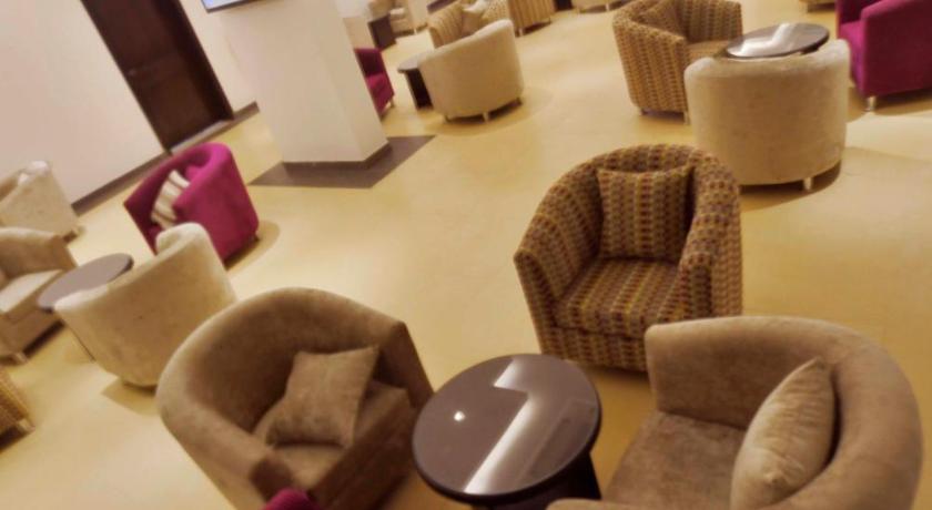 a living room filled with couches and chairs, City Suites in Al-Khobar
