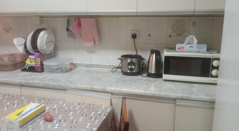 a kitchen with a microwave and a dishwasher, Transient furnished. Room just 1 min to Al ain mall in Al Ain