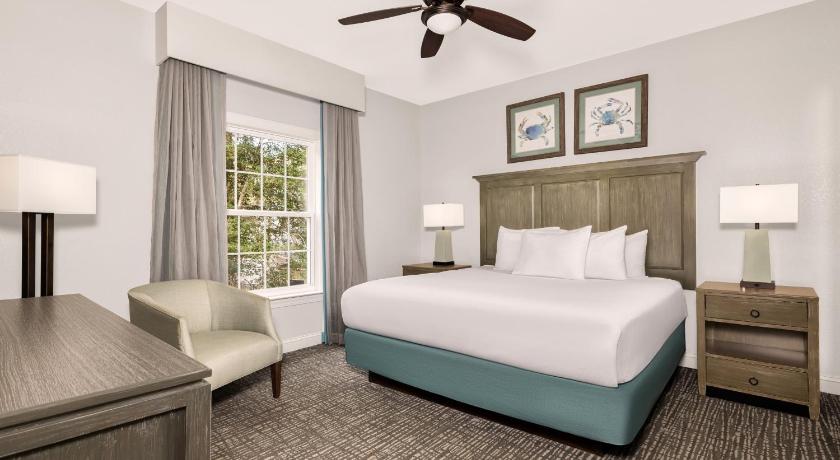 a bedroom with a large bed and a large window, Wyndham at The Cottages in Myrtle Beach (SC)