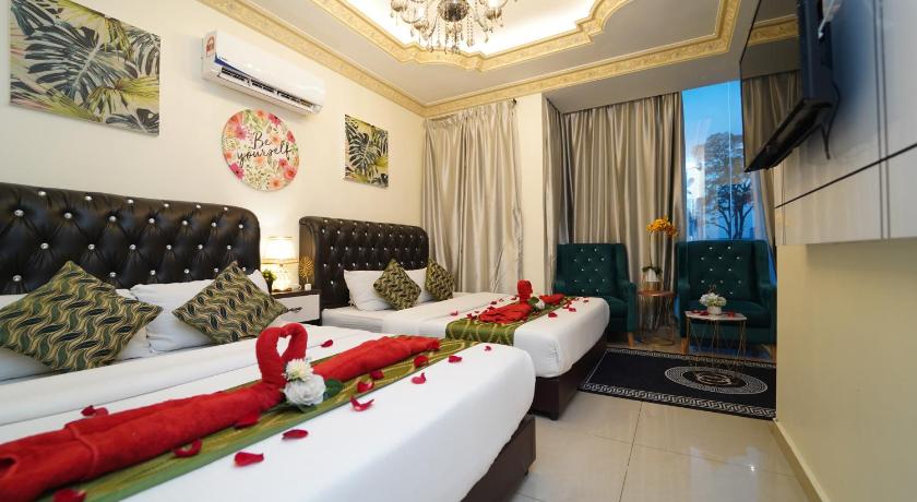 a living room with two couches and a television, Ghazrin's Classic Hotel in Johor Bahru