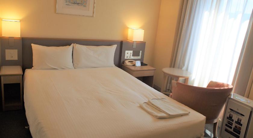a hotel room with two beds and a lamp, Hotel Jal City Nagano in Nagano