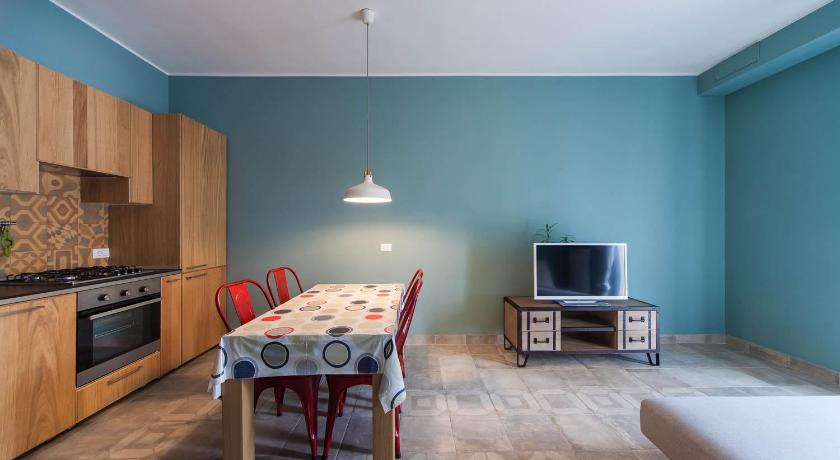 a kitchen with a table and chairs and a refrigerator, B&B Portorosso in Monopoli