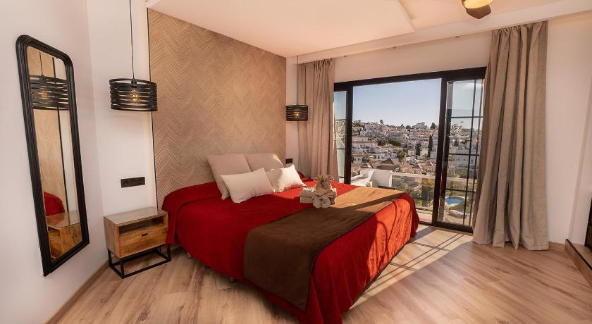 a bedroom with a large bed and a large window, Hostal Casa Mercedes in Nerja