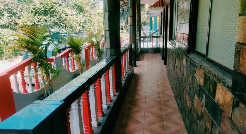 a walkway leading to a patio area with tables and chairs, Swizel Nook in Goa