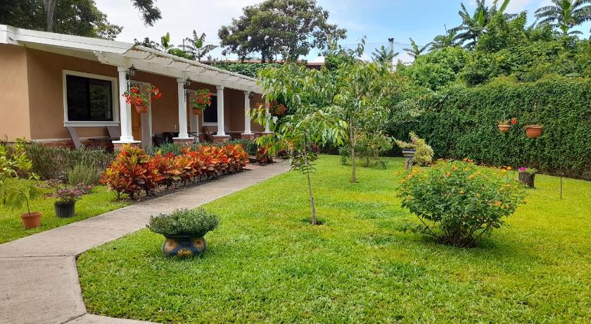 a garden filled with plants and a house, Airport Costa Rica B&B in Alajuela