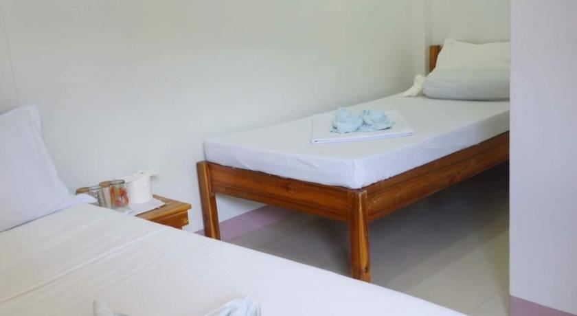 a hotel room with two beds and a desk, Sheryl May Inn in Palawan