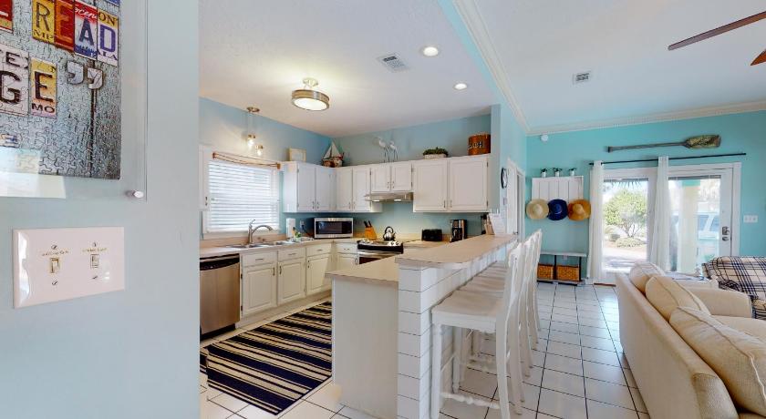 a kitchen with white cabinets and white appliances, Terra Cotta: Tropical Dreams in Destin (FL)