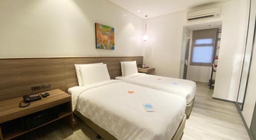 a hotel room with a bed and a desk, Go Hotels Plus Tuguegarao in Tuguegarao City
