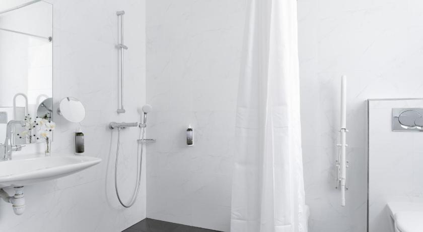 a bathroom with a shower, toilet and sink, Hotel Palm - Astotel in Paris