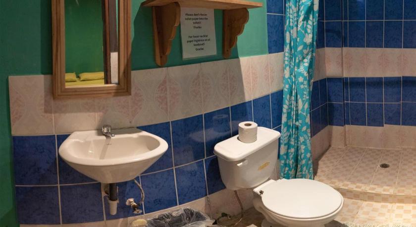 a bathroom with a toilet, sink, and bathtub, Valerie Emanuel Apartments in Bocas del Toro