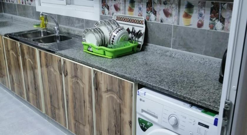 a kitchen with a sink and a microwave, Al Rawda Apartments -Ajman in Ajman