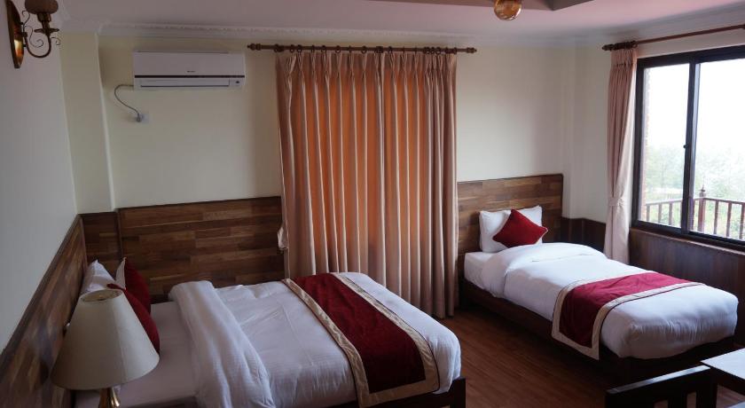 a hotel room with two beds and two lamps, Gaia Holiday Home in Kathmandu