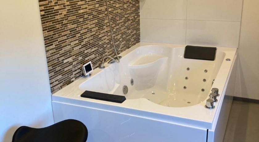 a white bath tub sitting next to a white toilet, Hotel-Chao NL in Utrecht