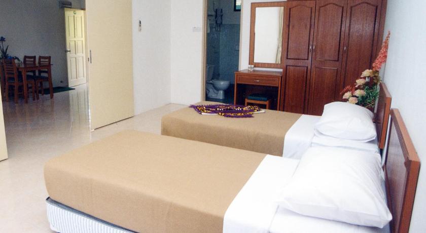 a hotel room with a bed and a dresser, Marina Cove Resort in Lumut