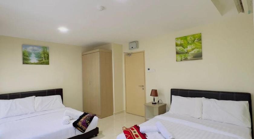 a hotel room with two beds and a television, Noor Hotel Kangar in Kangar