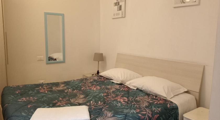 a bedroom with a bed and a lamp, Pisacentro Guest House in Pisa