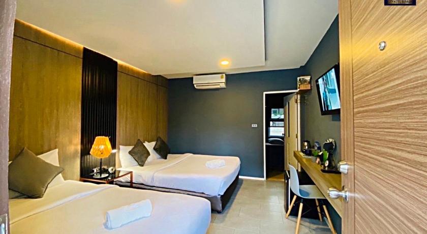 a hotel room with a bed and a television, S1 City Hotel in Buriram