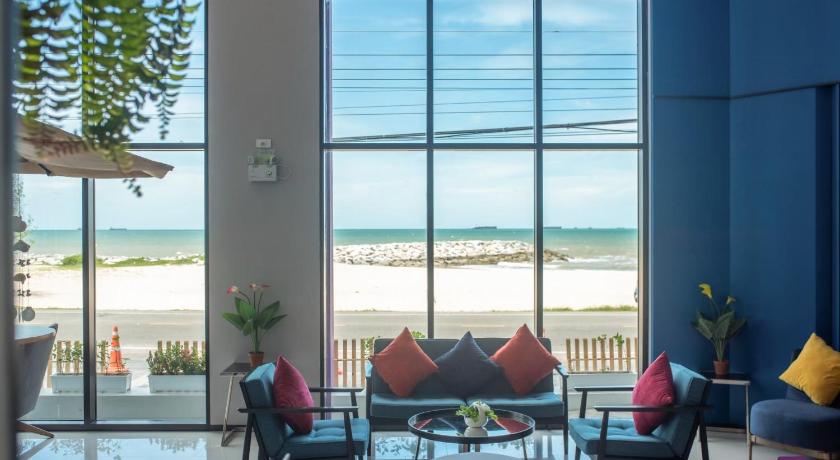 a living room filled with furniture and a window, Fortune Saeng Chan Beach Hotel Rayong (SHA Certified) in Rayong