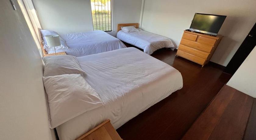 a bedroom with a bed and a television, Casa Campestre Villa Luna in Sogamoso