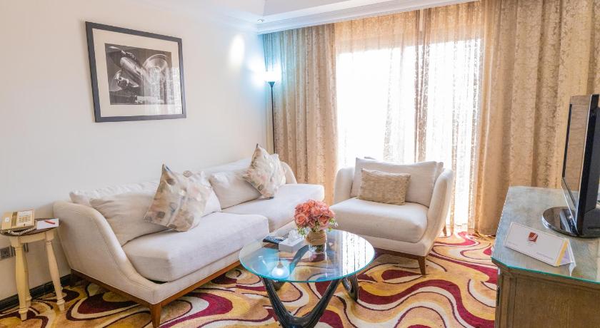 a living room filled with furniture and a couch, Ewan Ajman Suites Hotel in Ajman