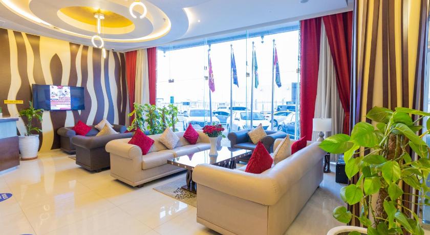 a living room filled with furniture and a window, Ewan Tower Hotel Apartments in Ajman