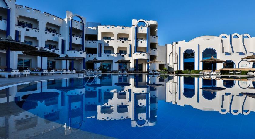 a large white swimming pool in front of a large building, Coral Sun Beach - Adults Only in Safaga