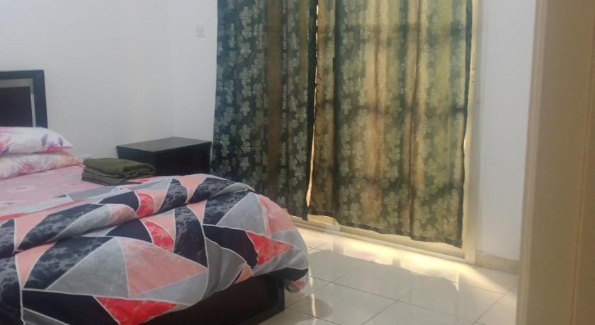 a bedroom with a bed and a desk, Furnished room in a villa in town center. With private bathroom in Al Ain