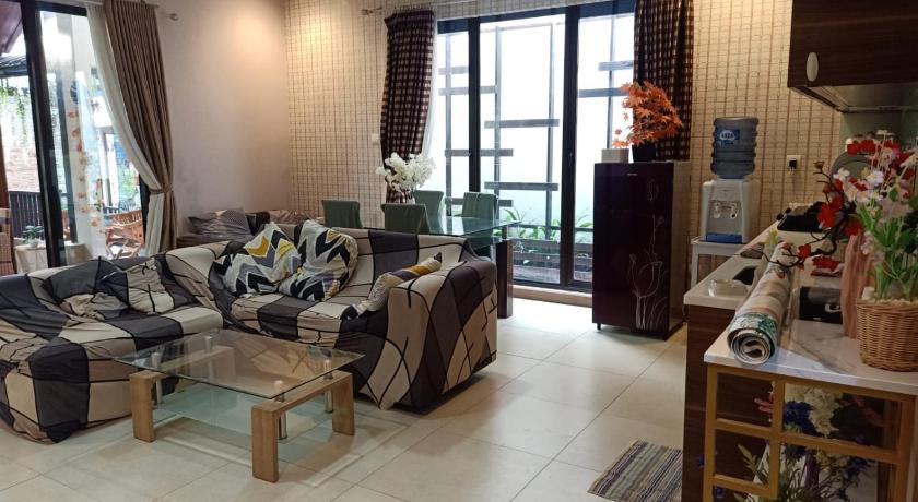 a living room filled with furniture and a large window, Vimalla Hills Villa & Resort Megamendung Puncak in Puncak
