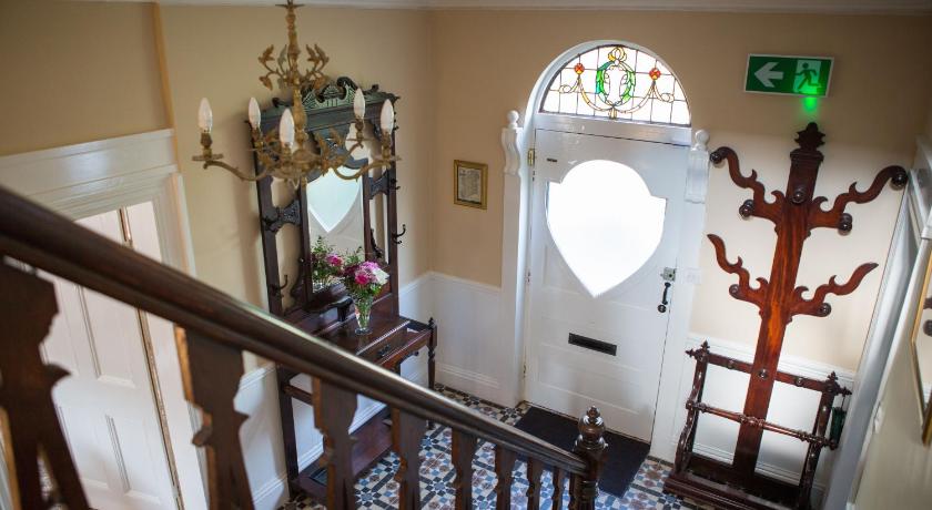 a staircase leading up to a room with a clock on the wall, Riverdale House B&B in Athlone